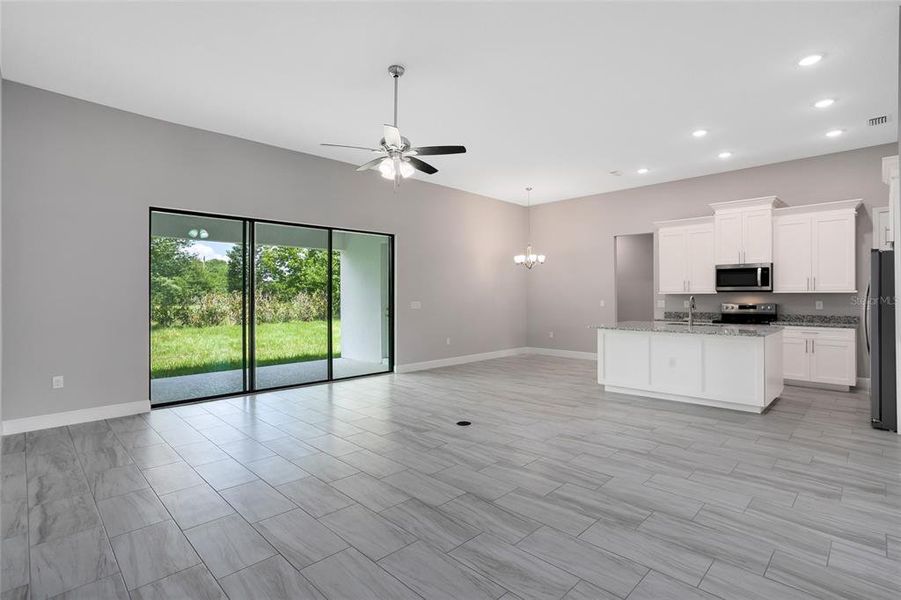 Your formal space is separate while still being connected to the OPEN CONCEPT family room and kitchen where TRIPLE SLIDING GLASS doors open up to the expansive covered lanai.