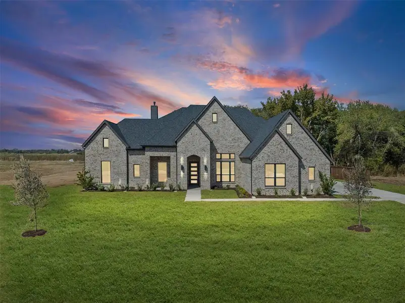 Front exterior of a new home in Waterfall Ranch - 1 Acre Lots, Waxahachie, TX, highlighting curb appeal (Image 2).