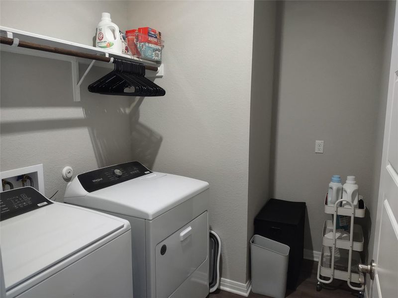 Laundry room featuring independent washer and dryer and baseboards
