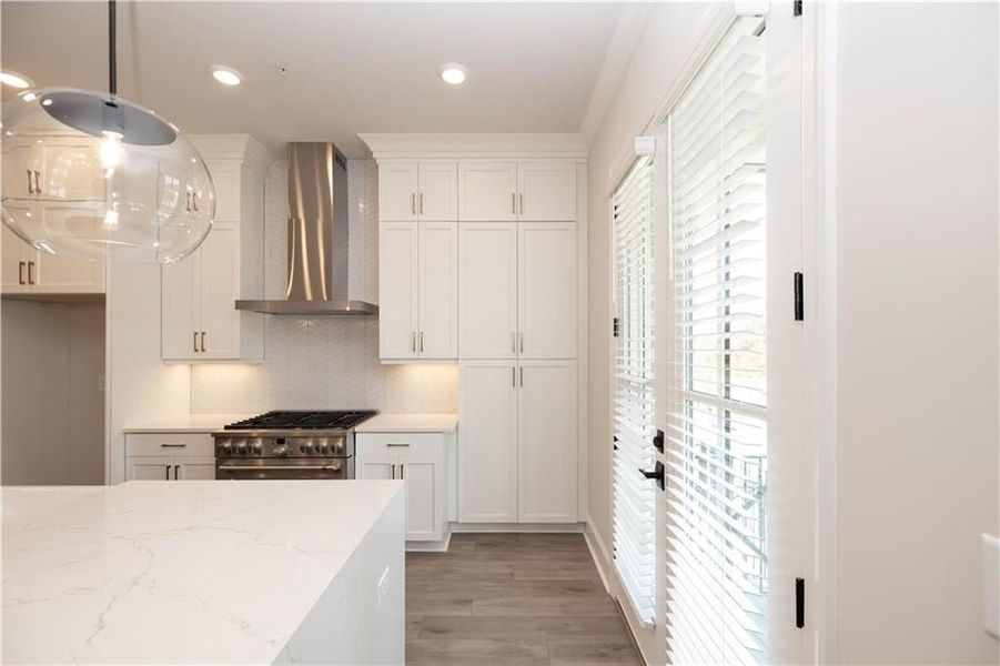 Tons of natural light illuminate your kitchen space with 8" balcony doors with blinds.