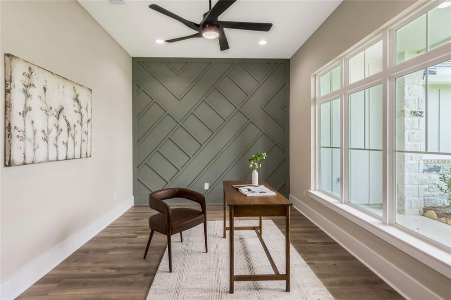 Home office with a stylish accent wall, large windows for natural light Home office with a stylish accent wall, large windows for natural light