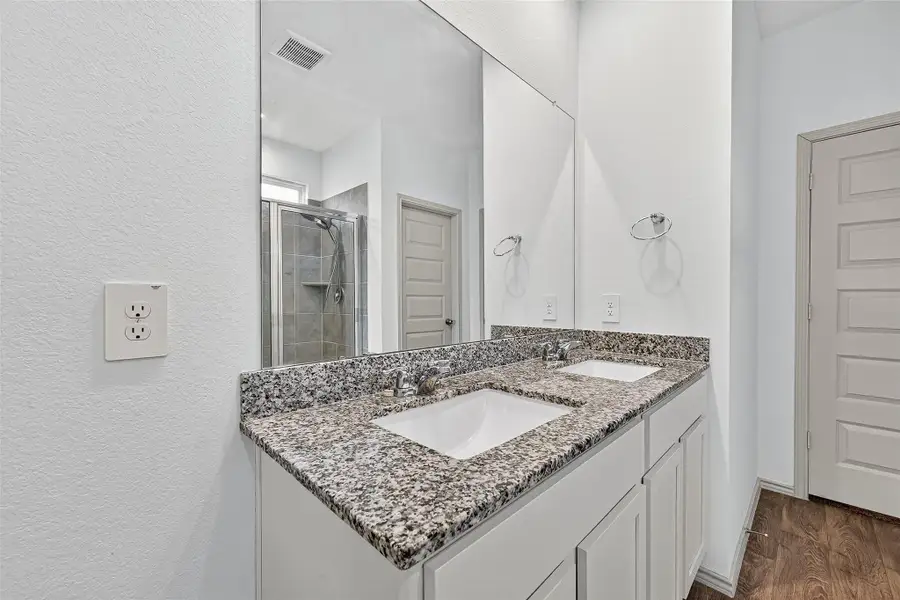 The primary bath also features double sinks for convenience.