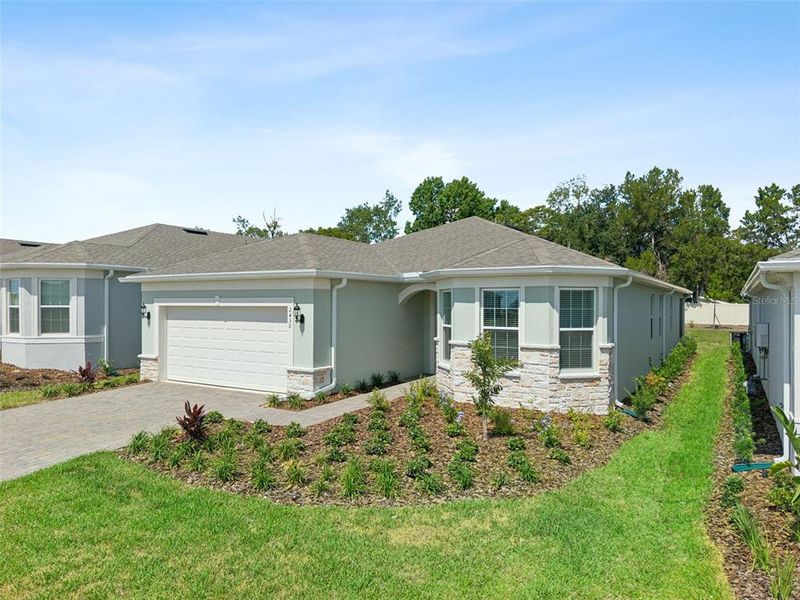 Front exterior of a new home in , Minneola, FL, highlighting curb appeal (Image 1). Front exterior of a new home in , Minneola, FL, highlighting curb appeal (Image 1).