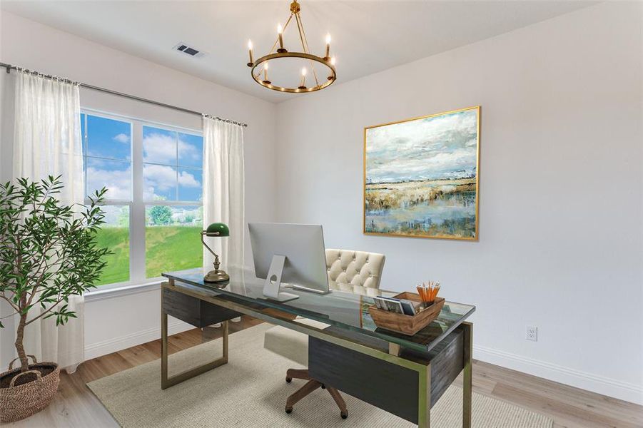 Home office featuring light wood-style flooring and a chandelier