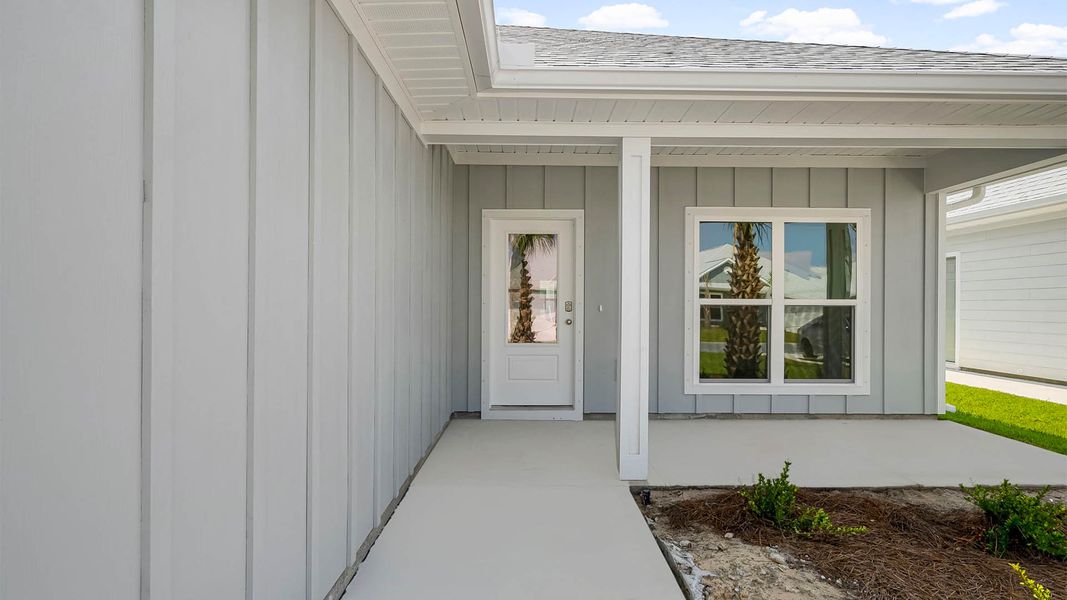 Front exterior of a new home in WindMark Beach, Port Saint Joe, FL, highlighting curb appeal (Image 15).