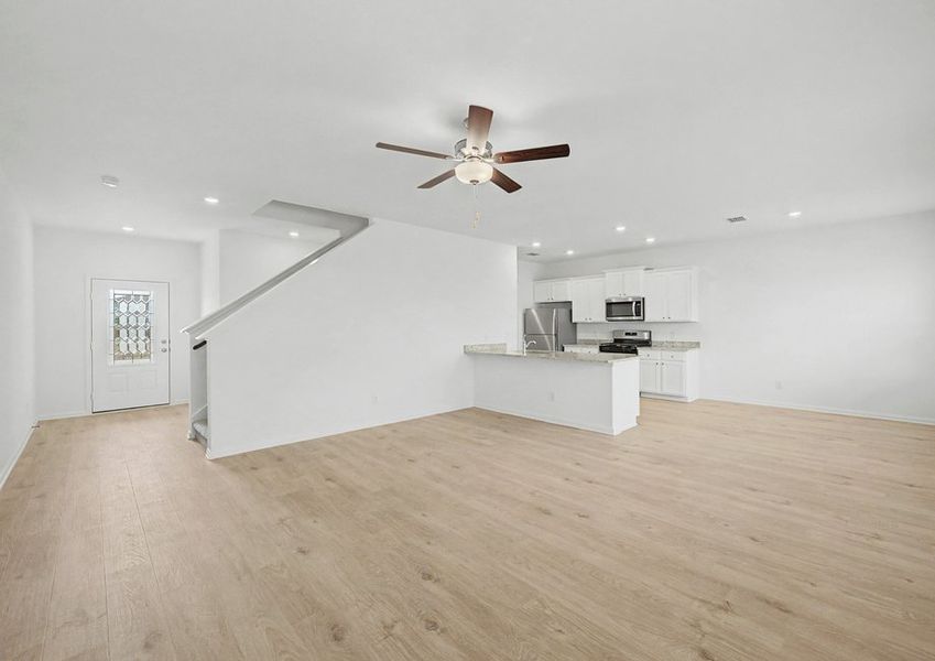 Open-concept layout with a spacious living room and upgraded kitchen.