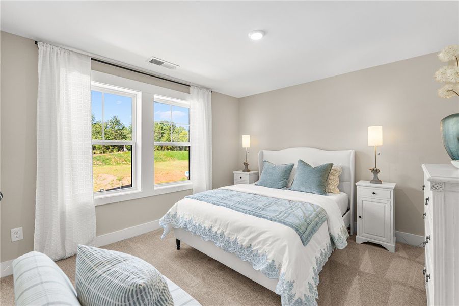 This inviting bedroom features ample natural light