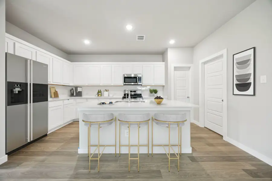 Kitchen in the Hayden home plan by Trophy Signature Homes – REPRESENTATIVE PHOTO