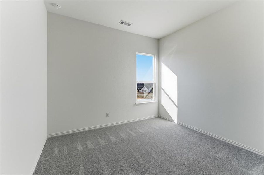 Spare room with carpet floors and baseboards
