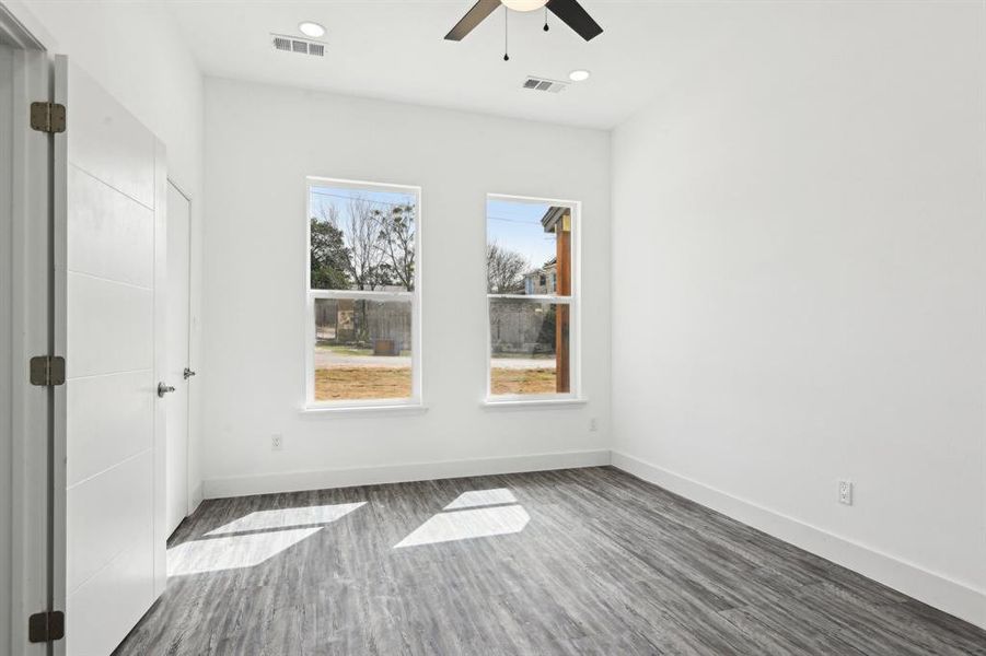 Unfurnished bedroom featuring recessed lighting, visible vents, ceiling fan, wood finished floors, and baseboards