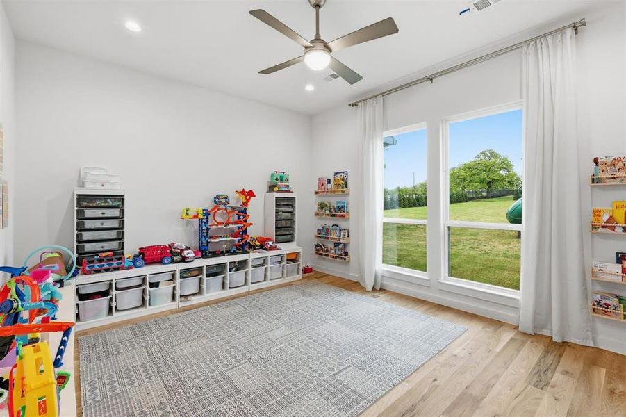 Playroom featuring light wood-type flooring, a ceiling fan, and recessed lighting