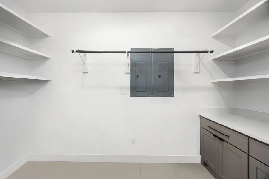 Spacious utility room with built-in sink, ample counter space, and storage—perfect for laundry, crafts, or extra organization.