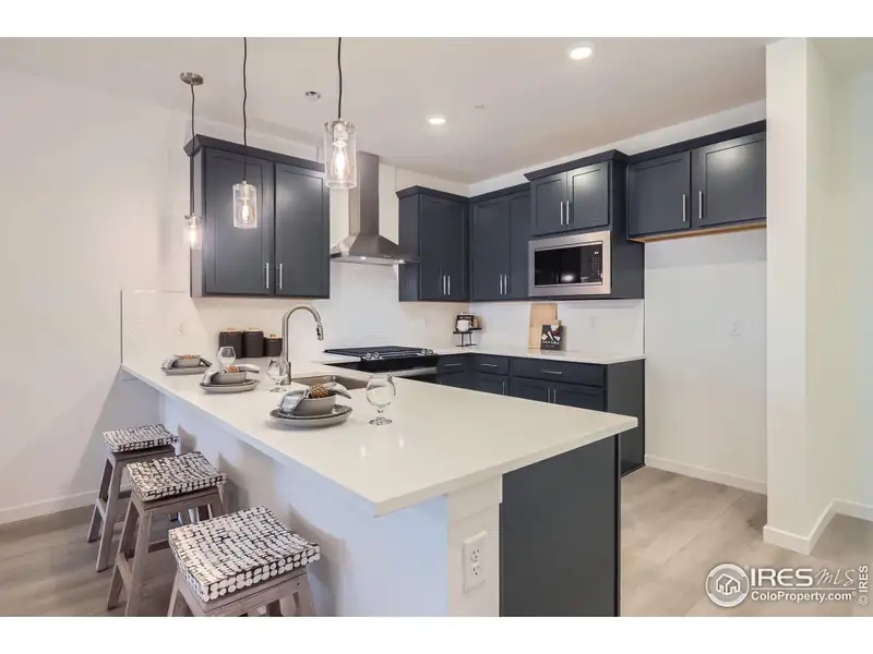 Included upgrades: Quartz, stainless steel appliances, soft close cabinets, pendant lighting.