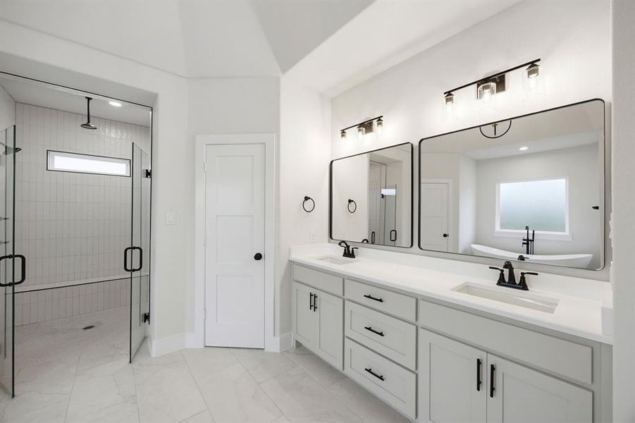 Dual vanity with white cabinetry, matte black hardware, and integrated sinks