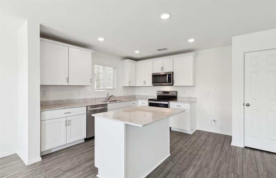 Airy kitchen with ample cabinet space*real home pictured