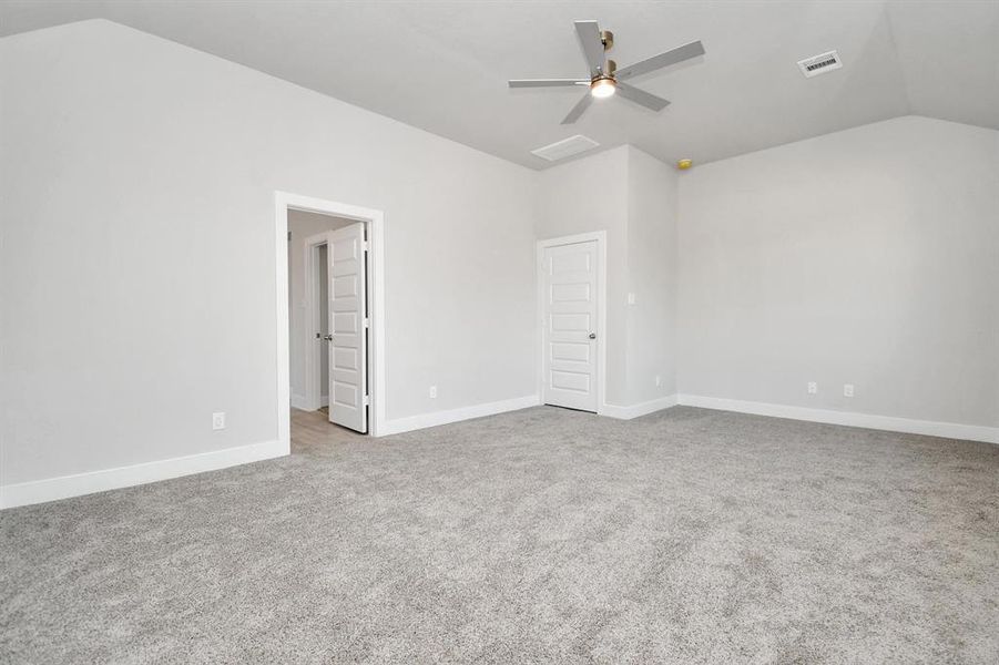 Relax and rejuvenate in the luxurious primary suite after a hectic day! This expansive space boasts cozy carpeting, inviting paint tones, lofty ceilings, and sizable windows adorned with privacy blinds. Sample photo of completed home. Actual colors and selections will vary.