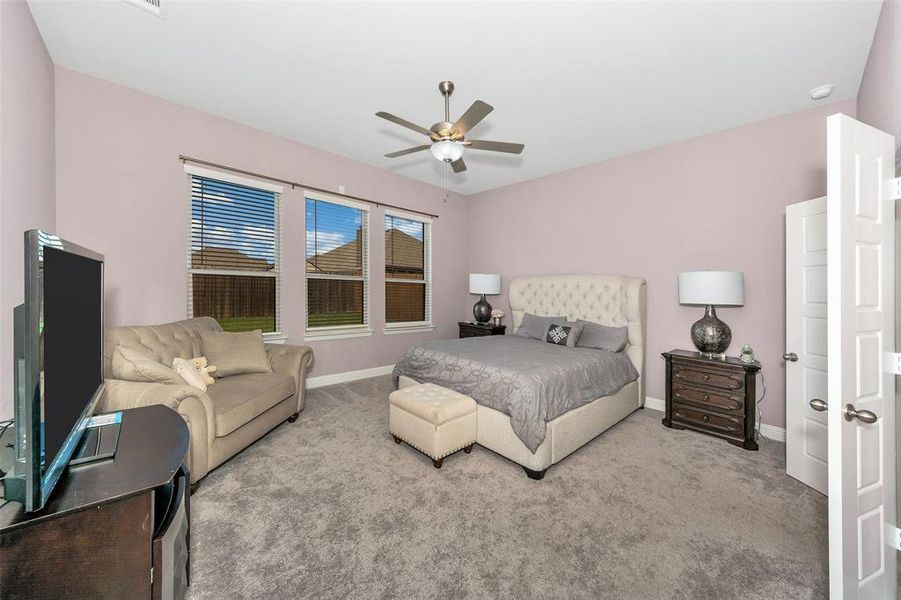 Bedroom featuring ceiling fan and light colored carpet