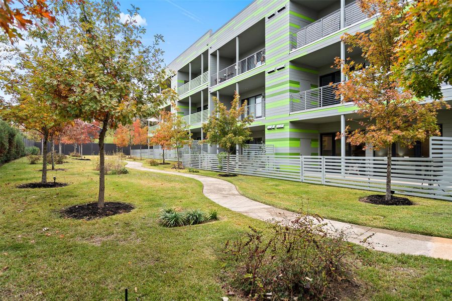 View of property's community with a lawn and fence