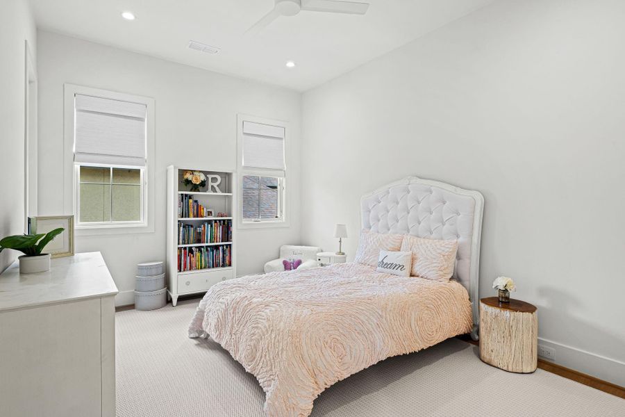 Located upstairs, this secondary bedroom #3 offers a bright & comfortable setting w/ two large windows overlooking the side yard, complete w/ custom woven Roman shades. Wide-plank white oak flooring continues throughout, while a ceiling fan adds everyday comfort. A walk-in closet w/ built-in drawers, shelving & hanging space provides excellent storage. Located upstairs, this secondary bedroom #3 offers a bright & comfortable setting w/ two large windows overlooking the side yard, complete w/ custom woven Roman shades. Wide-plank white oak flooring continues throughout, while a ceiling fan adds everyday comfort. A walk-in closet w/ built-in drawers, shelving & hanging space provides excellent storage.