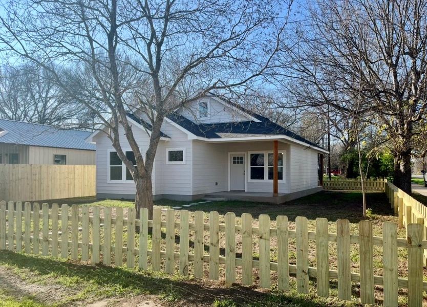 Back of property featuring a patio, a fenced backyard, and a shingled roof