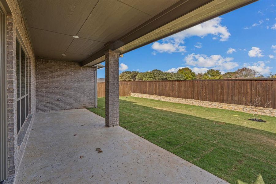 Fenced backyard with a patio area