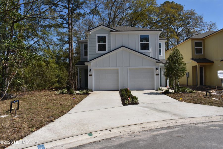 Front exterior of a new home in Irongate Villas, Jacksonville, FL, highlighting curb appeal (Image 2).