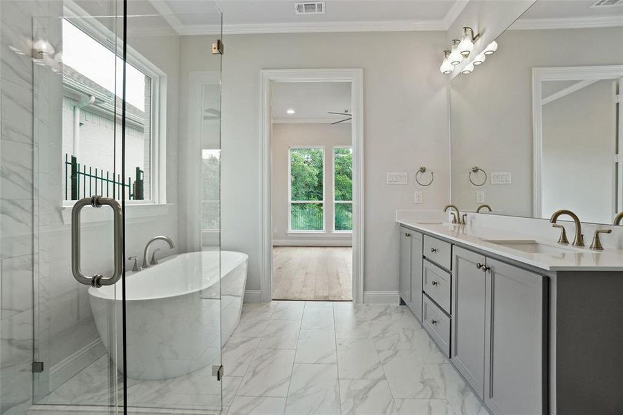 Bathroom with ornamental molding, dual vanity, tile patterned floors, and ceiling fan