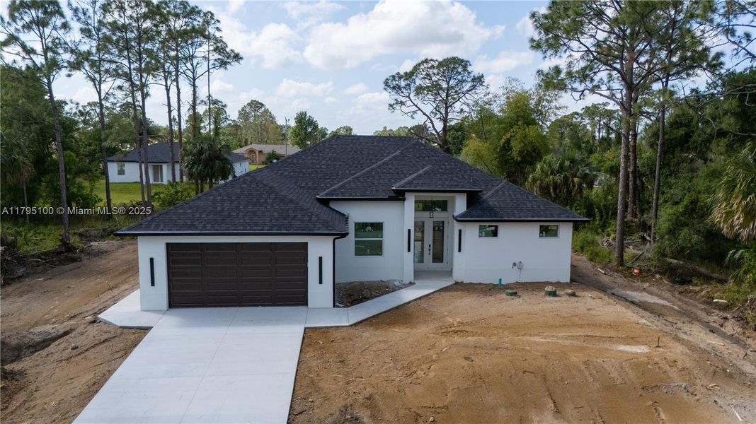 Front exterior of a new home in , Lehigh Acres, FL, highlighting curb appeal (Image 17).
