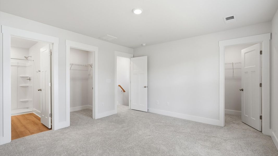 Accomplished primary retreat with eye-catching carpet flooring in a desirable Anderson community