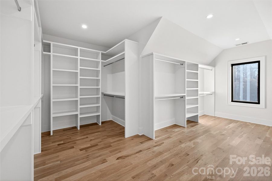 Master Bedroom Walk-in Closet. Shelving for sweaters, shoes, shirts, suits, skirts, dresses and coats.