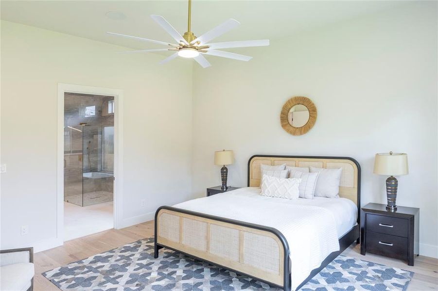 Bedroom with ceiling fan, hardwood / wood-style flooring, and ensuite bath