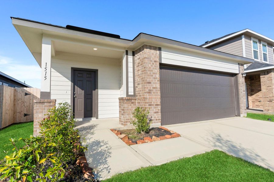 The Oak Plan features timeless architectural design and a spacious driveway with clean, modern curb lines. The covered porch and brick details add warmth and elegance to the exterior. The Oak Plan features timeless architectural design and a spacious driveway with clean, modern curb lines. The covered porch and brick details add warmth and elegance to the exterior.