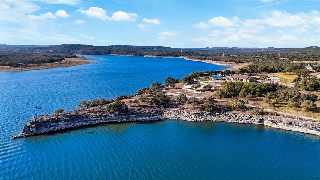 Panoramic blue waters surround this exceptional peninsula property on a sunny day. Panoramic blue waters surround this exceptional peninsula property on a sunny day.