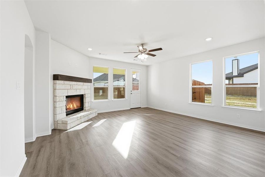 Unfurnished living room with light wood-type flooring, a fireplace, recessed lighting, and a ceiling fan