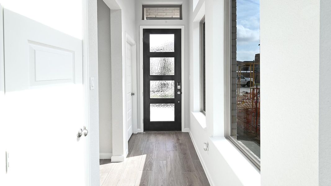Entryway with wood finished floors and baseboards Entryway with wood finished floors and baseboards