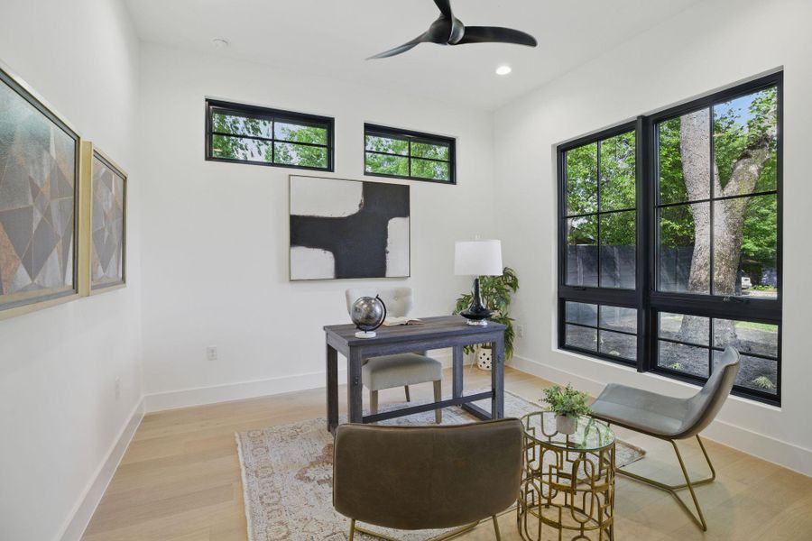 Office with light wood-type flooring, a ceiling fan, recessed lighting, and baseboards