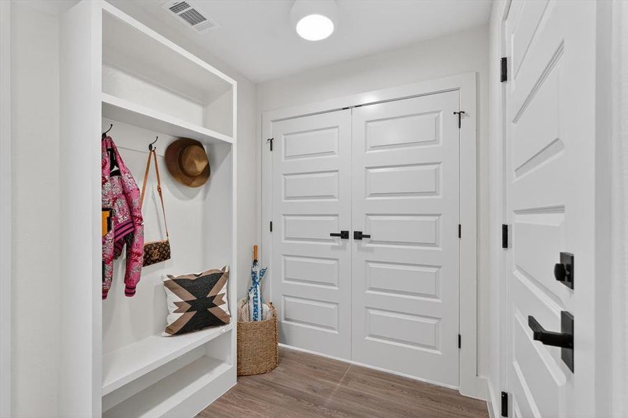 Built-in mudroom bench with shelving and coat hooks