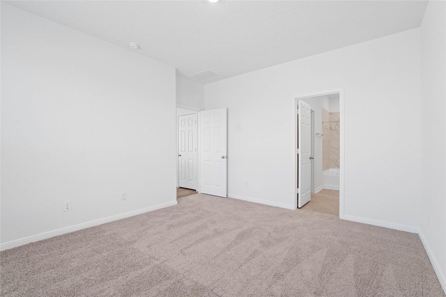 Additional view from primary bedroom looking into the ensuite primary bathroom.