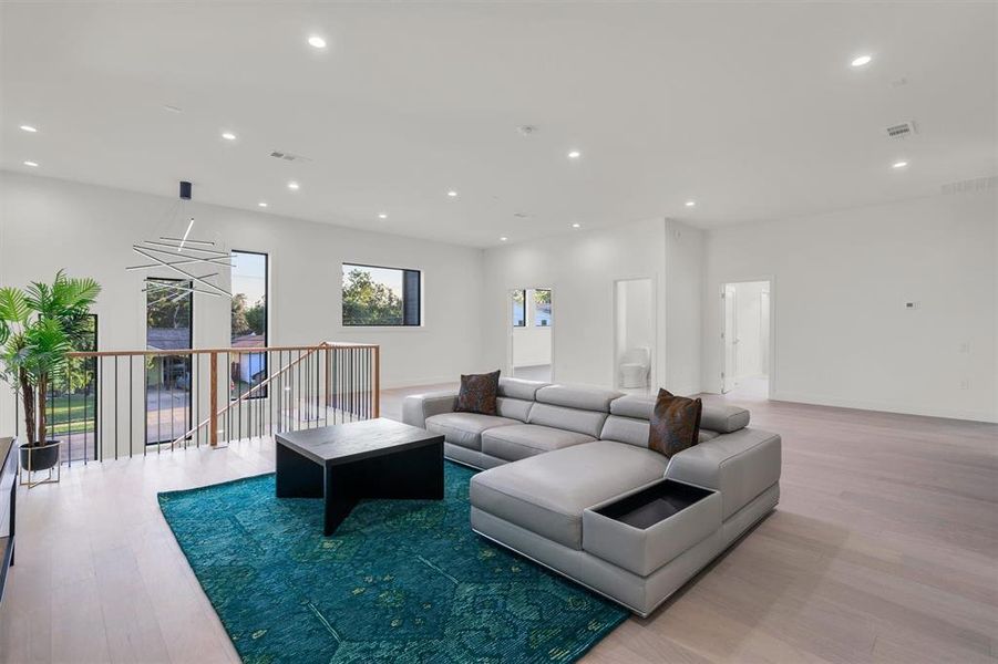 Living room featuring hardwood / wood-style floors and a notable chandelier