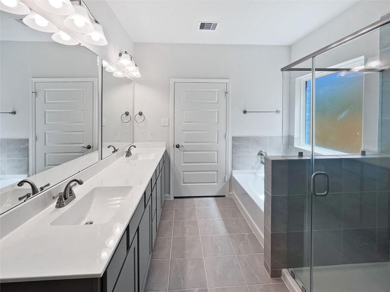 The Princeton II- Primary Bathroom with Dual Skinks, Separate Garden Tub and Walk-in Shower. Home under construction, image used for illustrative purposes only, colors and options will vary. The Princeton II- Primary Bathroom with Dual Skinks, Separate Garden Tub and Walk-in Shower. Home under construction, image used for illustrative purposes only, colors and options will vary.