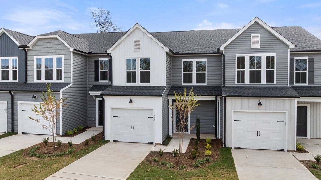 Front exterior of a new home in Poets Walk, Whitsett, NC, highlighting curb appeal (Image 1).