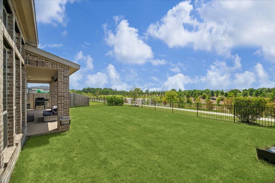 Spacious backyard with lush green space, peaceful water views and no rear neighbors