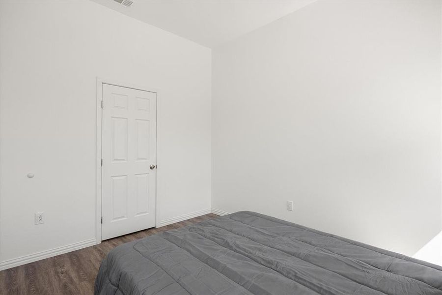 Unfurnished bedroom with wood-type flooring