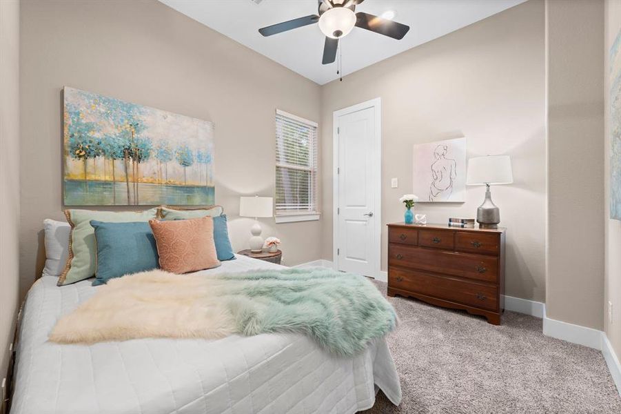 This beautiful secondary bedroom also is facing the front of the house and the window brings in light and loads of forested nature just outside.