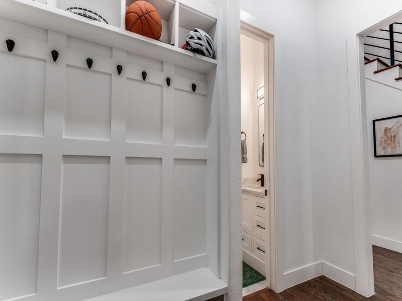 Mudroom featuring dark wood-type flooring and baseboards