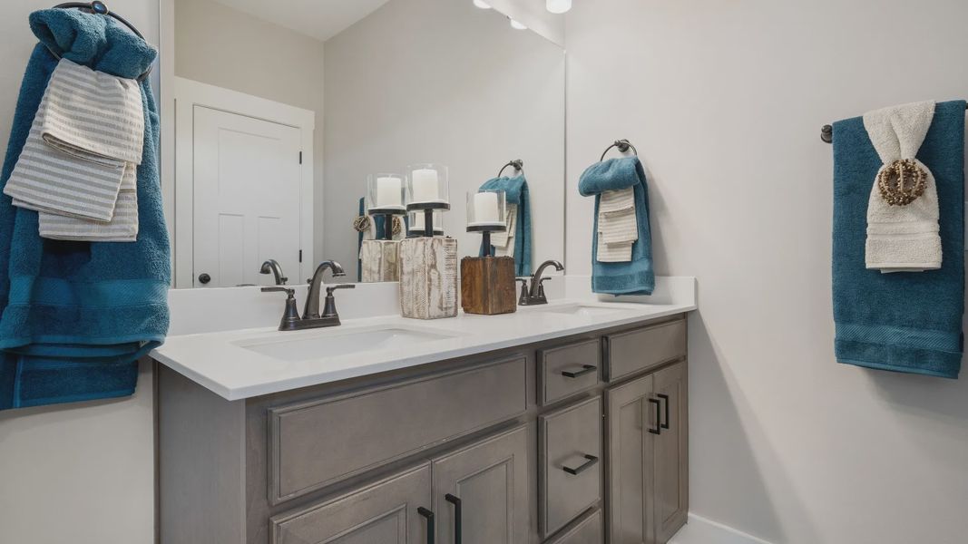 First-rate primary bathroom offering an elegant walk-in shower and dual sinks with superior style at Benjamin's Grove