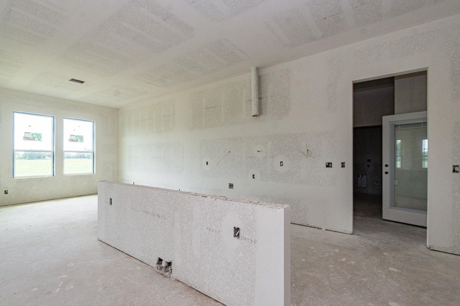Spacious unfinished open kitchen to dining room with large windows, offering abundant natural light and potential for customization. Spacious unfinished open kitchen to dining room with large windows, offering abundant natural light and potential for customization.