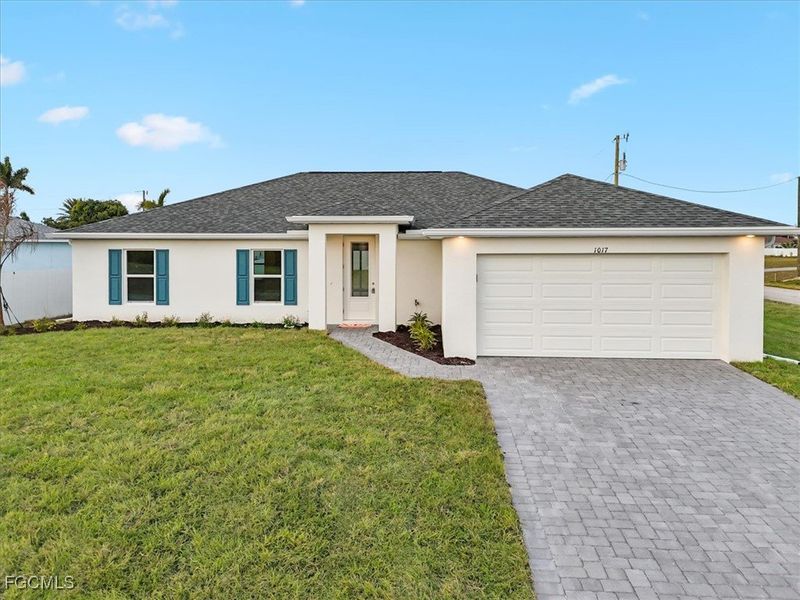 Front exterior of a new home in Cape Coral, Cape Coral, FL, highlighting curb appeal (Image 1). Front exterior of a new home in Cape Coral, Cape Coral, FL, highlighting curb appeal (Image 1).