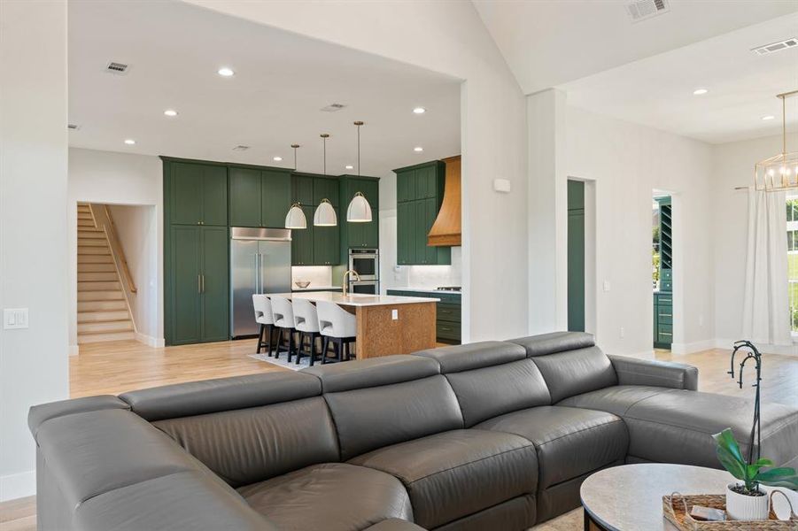 Living room featuring a notable chandelier and light hardwood / wood-style flooring