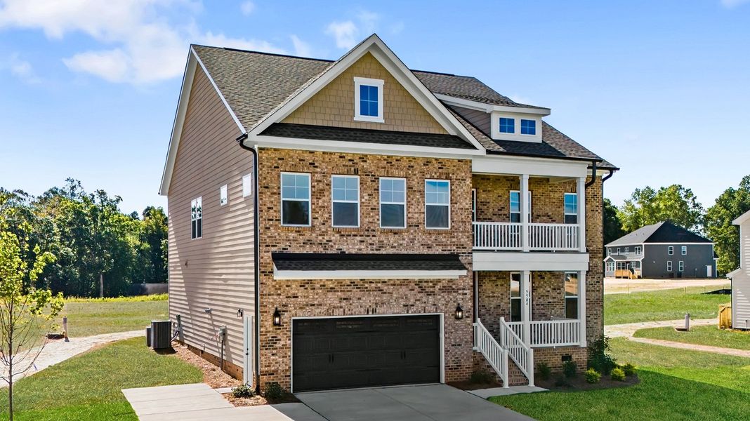 Front exterior of a new home in Lilah Grove, Summerfield, NC, highlighting curb appeal (Image 27). Front exterior of a new home in Lilah Grove, Summerfield, NC, highlighting curb appeal (Image 27).